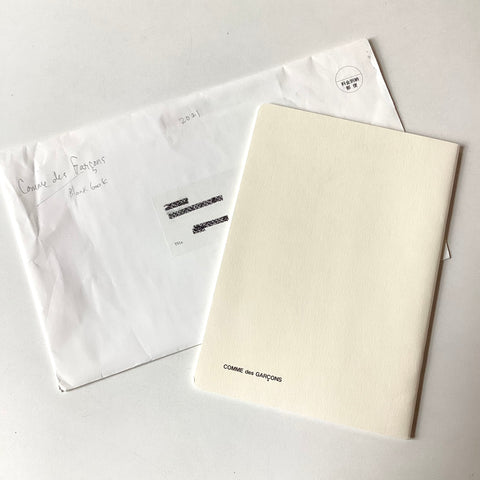 Comme des Garçons blank notebook in envelope